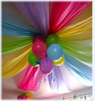 Wonderful atmosphere created by colourful roof drapes and balloons